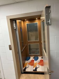 Windowed home elevator overlooking a pond and golf course in Dakota Dunes